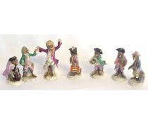 Collection of seven Continental monkey band figures including a conductor and musicians, the