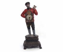 Painted base metal novelty timepiece modelled in the form of a clock seller wearing a red tunic