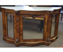 Victorian walnut serpentine front credenza fitted with three mirrored doors with carved scrolling