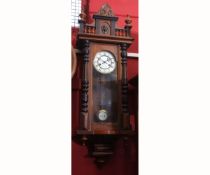 Late 19th century walnut and ebonised Vienna type wall clock, the overhanging cornice with shaped