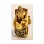 Japanese ivory netsuke of a fisherman holding a fish, signature to his back, 4 1/2cms tall