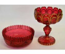 Cranberry red bowl with gilded decoration with castolated top on a circular foot together with