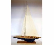 Modern painted and varnished pond yacht, set with mainsail and jib to a fitted deck and blue hull