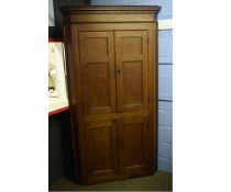Oak full height corner cupboard, fitted with four panelled doors, 47cms wide x 214cms high