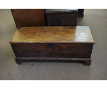 17th century elm six-planked coffer with blue silk lined interior, raised on bracket feet, 120cms