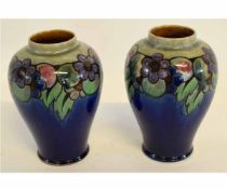 Pair of mid-20th century Royal Doulton vases with blue ground and tube lined floral and fruit