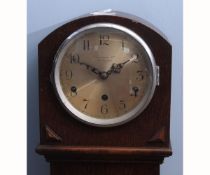 Mid-20th century oak cased floor standing triple barrel clock, the arched hood to a moulded throat