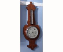 Mid-20th century mahogany and inlaid aneroid wheel barometer, the shaped case set with a