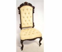 Victorian mahogany prie-deux chair with fruit carved top rail and cream upholstered and button