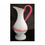 Good quality opaque glass jug with a shaped cranberry with a handle formed as a gilded serpent,