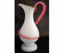 Good quality opaque glass jug with a shaped cranberry with a handle formed as a gilded serpent,