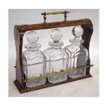 19th century walnut framed tantalus fitted with four square clear glass decanters with faceted