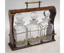 19th century walnut framed tantalus fitted with four square clear glass decanters with faceted