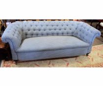 Victorian mahogany framed two-seater Chesterfield sofa with blue and floral upholstery, raised on