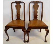 Set of four Edwardian mahogany splat back dining chairs with tan leather drop in seats and carved