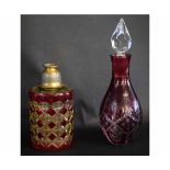 Circular ruby and clear cut glass scent bottle with metal mounted top, together with a further