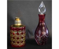 Circular ruby and clear cut glass scent bottle with metal mounted top, together with a further