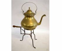 19th century brass and cast three-foot trivet with turned oak handle, together with a bulbous formed