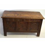 Early 18th century oak three-panelled front coffer with floral carved detail, with partially