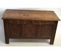Early 18th century oak three-panelled front coffer with floral carved detail, with partially