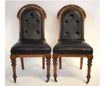 Pair of 19th century oak framed arch top hall chairs with black rexine upholstered seats and