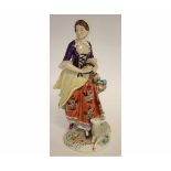 Mid-20th century German porcelain model of a shepherdess after Meissen, playing a tambourine with