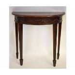 Mahogany demi-lune side table with carved swags and urn detail on tapering square spade feet,