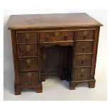 18th century style oak kneehole desk with central panelled cupboard with draw above, flanked