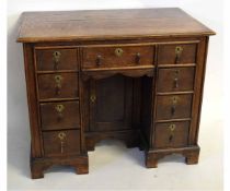 18th century style oak kneehole desk with central panelled cupboard with draw above, flanked