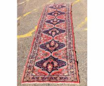 Modern floor runner with repeating floral lozenge centre with blue ground, with multi-gulled border,