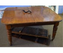 Edwardian oak extending dining table on four ring turned legs, raised on porcelain casters (with