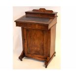 Victorian walnut Davenport with inlaid detail and brown leather inserts, raised on porcelain