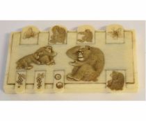 Ivory whist marker decorated with apes in relief