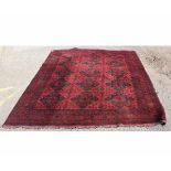 Bokhara carpet with red field with diamond repeating design to centre, multi-gulled border, 205cms