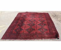 Bokhara carpet with red field with diamond repeating design to centre, multi-gulled border, 205cms