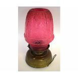 Late 19th/early 20th century lamp with large shaped pink glass shade, 44cms high