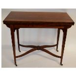 Edwardian walnut fold-over card table with inlaid stringing and green baize fitted interior,