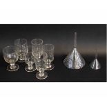 Group of glass wares including wine glasses and two glass funnels