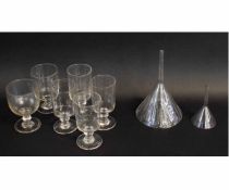 Group of glass wares including wine glasses and two glass funnels