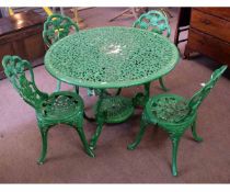 Green painted circular cast aluminium pierced top garden table, together with a set of four cast