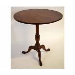 Georgian mahogany circular tilt top table with turned urn formed column on a tripod base, 74cms diam