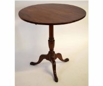 Georgian mahogany circular tilt top table with turned urn formed column on a tripod base, 74cms diam