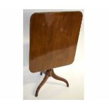 Georgian mahogany rectangular tilt top table with a turned column tapering to a tripod reeded