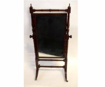 Regency mahogany cheval mirror with ring turned supports, raised on sabre legs and brass capped