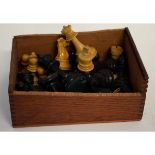 Box containing assorted carved and stained chess pieces