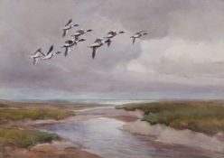 AR ROLAND GREEN (1896-1972) Shelduck in flight over an estuary watercolour, signed lower left 28 x