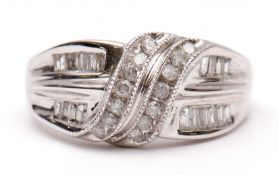 Modern precious metal and diamond cluster ring, knot design set with circular cut and baguette