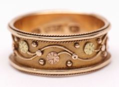 Antique 18ct stamped ring, the wide waisted band with a continuous two-tone gold coloured floral and