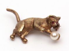 Modern 9ct gold cat brooch, a textured design set with two small circular cut ruby eyes and small