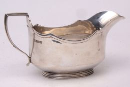 George VI gravy boat of polished oval form with applied and shaped rim and handle on spreading